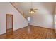 Spacious living room featuring laminate flooring, vaulted ceilings, and staircase access at 10020 Creekwater Blvd, Orlando, FL 32825