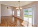 Open floor plan: living room with laminate floors leads to a dining area and sliding glass doors to backyard at 10020 Creekwater Blvd, Orlando, FL 32825