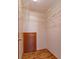 Walk-in closet with adjustable shelves, closet rod for hanging clothes, and flooring at 10020 Creekwater Blvd, Orlando, FL 32825
