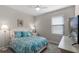 Inviting bedroom featuring a patterned bedspread, plush pillows, a ceiling fan, and natural light at 10655 Village Lake Rd, Windermere, FL 34786