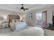 Bedroom with ceiling fan and access door to a private balcony at 10655 Village Lake Rd, Windermere, FL 34786
