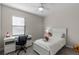 Cozy bedroom with a ceiling fan, a white desk, and a comfortable bed, perfect for relaxation at 10655 Village Lake Rd, Windermere, FL 34786