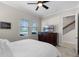 Cozy bedroom with large bed, ceiling fan, and natural light, offering a serene retreat at 10655 Village Lake Rd, Windermere, FL 34786