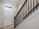 Bright entryway with staircase, white door, and neutral tile flooring creating a welcoming ambiance at 10655 Village Lake Rd, Windermere, FL 34786