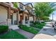 Charming townhouse with stone accents, well-manicured lawn, and inviting covered entryway at 10655 Village Lake Rd, Windermere, FL 34786