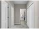 Bright hallway with neutral walls, carpeted floor, and access to bedroom, bathroom, and closet at 10655 Village Lake Rd, Windermere, FL 34786