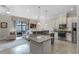 Spacious kitchen with stainless appliances, tile floors, and granite countertops at 10655 Village Lake Rd, Windermere, FL 34786