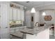 Kitchen with granite counters, white cabinets, and stainless steel faucet at 10655 Village Lake Rd, Windermere, FL 34786