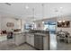 Open-concept kitchen with stainless steel appliances and a view of outdoor living at 10655 Village Lake Rd, Windermere, FL 34786