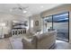 Living room with view of covered outdoor living area with fan at 10655 Village Lake Rd, Windermere, FL 34786