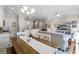 Open living and dining area with view into kitchen with white cabinetry at 10655 Village Lake Rd, Windermere, FL 34786