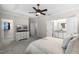 Open Primary bedroom with walk-in closet, dresser with TV, and ensuite bathroom, offering a comfortable retreat at 10655 Village Lake Rd, Windermere, FL 34786