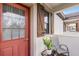 Cozy outdoor patio with a chair, small table, and charming architectural details at 10655 Village Lake Rd, Windermere, FL 34786