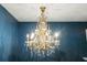 Stunning chandelier with crystal accents and gold metal finish hangs from the ceiling at 110 Wekiva Pointe Cir, Apopka, FL 32712