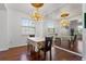 Dining area with a beautiful chandelier and large mirror, perfect for entertaining at 110 Wekiva Pointe Cir, Apopka, FL 32712