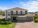 Charming two-story home boasts a three-car garage, manicured lawn, and mature landscaping at 110 Wekiva Pointe Cir, Apopka, FL 32712