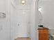 Hallway has a half bathroom with black countertops, beige tile flooring, and white walls at 110 Wekiva Pointe Cir, Apopka, FL 32712