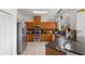 Bright kitchen with stainless steel appliances, wood cabinets, and granite countertops at 110 Wekiva Pointe Cir, Apopka, FL 32712