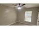 Cozy bedroom featuring neutral walls, natural light, and a ceiling fan at 111 Sunnyside Dr, Clermont, FL 34711