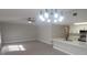 Bright, open living space with new flooring and modern lighting, connected to updated kitchen at 111 Sunnyside Dr, Clermont, FL 34711