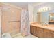 Functional bathroom featuring a shower-tub combination and a vanity with ample counter space at 1148 Monroe Ave, St Cloud, FL 34769
