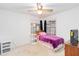 Bright bedroom with a single bed, carpet floors, a ceiling fan, and two windows at 1148 Monroe Ave, St Cloud, FL 34769