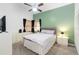 Cozy bedroom with a queen bed, a ceiling fan, and a large window for ample natural light at 1148 Monroe Ave, St Cloud, FL 34769
