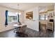 Cozy dining area featuring a pendant light, laminate flooring, window view, and seamless kitchen access at 1148 Monroe Ave, St Cloud, FL 34769