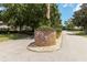 Community sign and entrance with mature landscaping at 1148 Monroe Ave, St Cloud, FL 34769