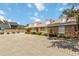 Brick building with a paved parking area and a community pool in the background at 1148 Monroe Ave, St Cloud, FL 34769