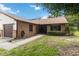 Welcoming brick home featuring an attached garage, landscaped front yard, and a well-maintained walkway at 1148 Monroe Ave, St Cloud, FL 34769