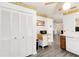 Bright kitchen featuring white cabinets, white appliances, and a view into the home at 1148 Monroe Ave, St Cloud, FL 34769
