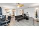 Open-concept living room with modern flooring, ceiling fan, neutral decor, and seamless flow at 1148 Monroe Ave, St Cloud, FL 34769