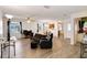 Expansive living area boasting wood laminate floors, ceiling fan, ample seating, and bright, open space at 1148 Monroe Ave, St Cloud, FL 34769