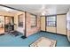 Versatile sunroom with blue floors, multiple windows, ceiling fan and brick accent wall at 1148 Monroe Ave, St Cloud, FL 34769