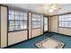 Bright sunroom featuring a light blue floor, multiple windows, and a ceiling fan at 1148 Monroe Ave, St Cloud, FL 34769
