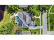 This aerial view showcases a home with a sparkling pool, stone patio, and lush landscaping at 116 Cherry Creek Cir, Winter Springs, FL 32708