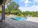 Backyard featuring a private pool, manicured landscaping, and serene water views at 116 Cherry Creek Cir, Winter Springs, FL 32708