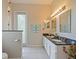 Bright bathroom with double granite vanity, neutral walls and decorative elements at 116 Cherry Creek Cir, Winter Springs, FL 32708