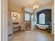 An elegant bathroom featuring a chandelier, a free-standing tub, a glass shower, and a double vanity at 116 Cherry Creek Cir, Winter Springs, FL 32708