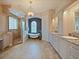 Spacious bathroom featuring a chandelier, free-standing tub, glass shower, and dual sinks with granite countertops at 116 Cherry Creek Cir, Winter Springs, FL 32708