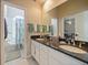 Bathroom with dual sinks, granite counters, and large mirror at 116 Cherry Creek Cir, Winter Springs, FL 32708