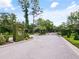 Welcoming entrance to the community with lush greenery, trees, and a secure gate at 116 Cherry Creek Cir, Winter Springs, FL 32708