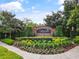 Elegant community sign with manicured landscaping creates a welcoming entrance at 116 Cherry Creek Cir, Winter Springs, FL 32708