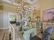 Formal dining room featuring an ornate chandelier, glass table, and elegant decor at 116 Cherry Creek Cir, Winter Springs, FL 32708