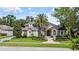 Charming home featuring stone accents, a well-manicured lawn, and lush landscaping at 116 Cherry Creek Cir, Winter Springs, FL 32708