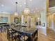 Kitchen island with pendant lighting, bar seating, and an open-concept design at 116 Cherry Creek Cir, Winter Springs, FL 32708