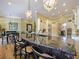 Granite topped Kitchen island with pendant lighting, bar seating, and an open-concept design at 116 Cherry Creek Cir, Winter Springs, FL 32708