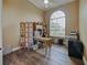 Bright home office with wood floors, modern desk, and arched window at 116 Cherry Creek Cir, Winter Springs, FL 32708