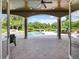 Covered outdoor living space with a luxurious pool, scenic views, and comfortable seating at 116 Cherry Creek Cir, Winter Springs, FL 32708